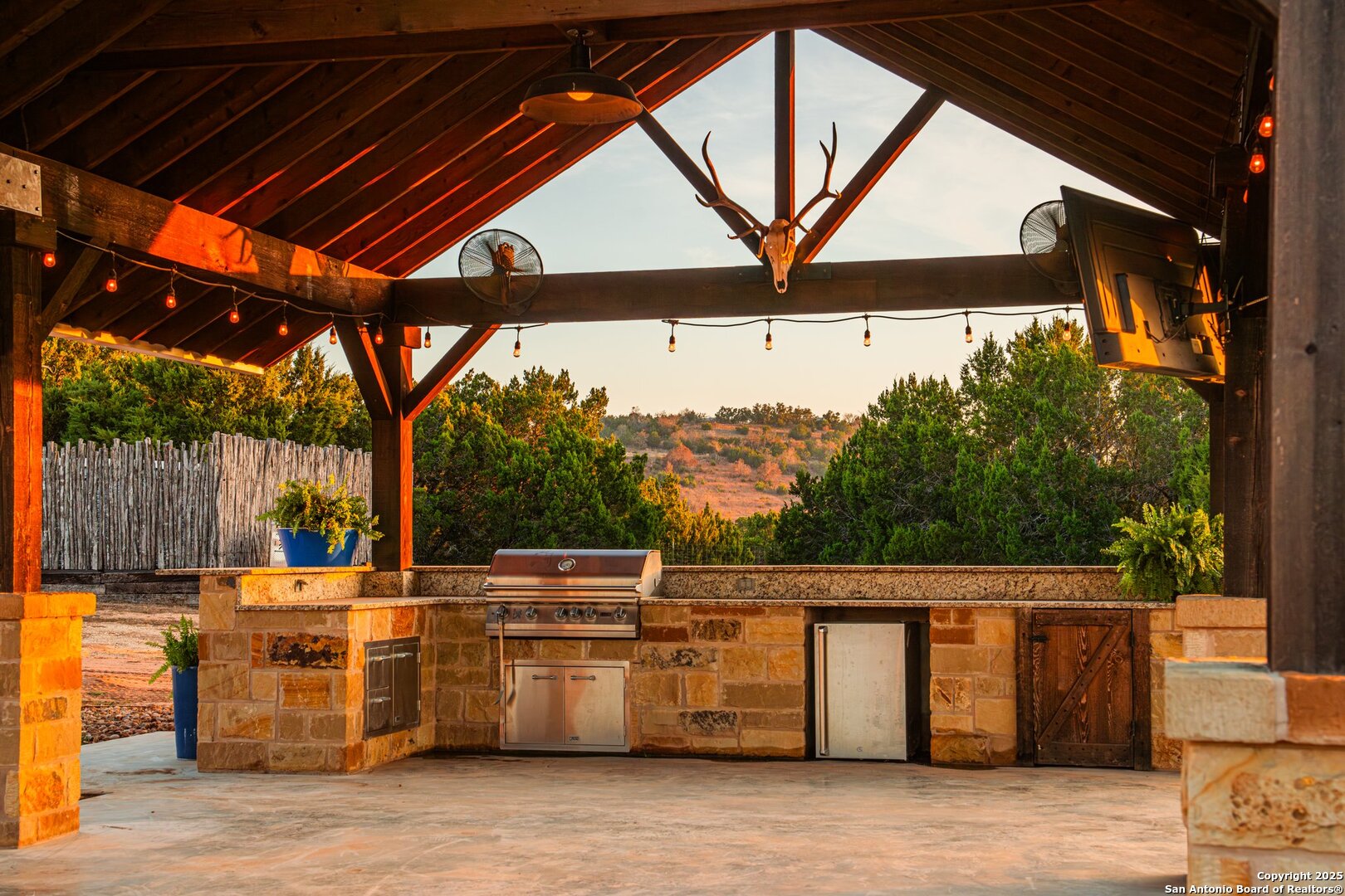 34 Rusty Spur Drive Fredericksburg, TX 78624 - Photo 42 of 49 a view of a patio with table and chairs under an umbrella with a small yard