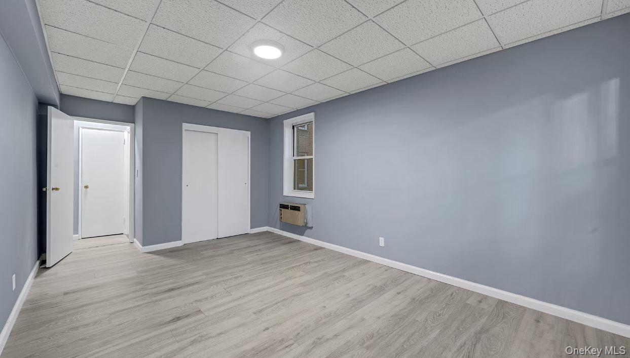 609 Palmer Road, Unit 3M Yonkers, NY 10701 - Photo 11 of 18 Opposite view of the bedroom featuring wood finished floors, a paneled ceiling, and a closet large enough to fit a king size bed and furniture.
