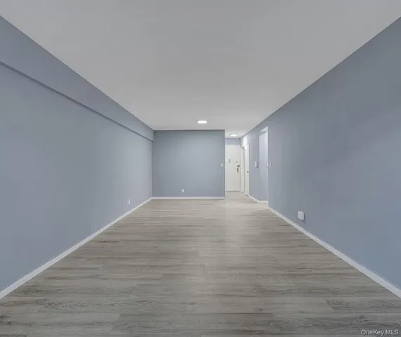 a view of an empty room and wooden floor