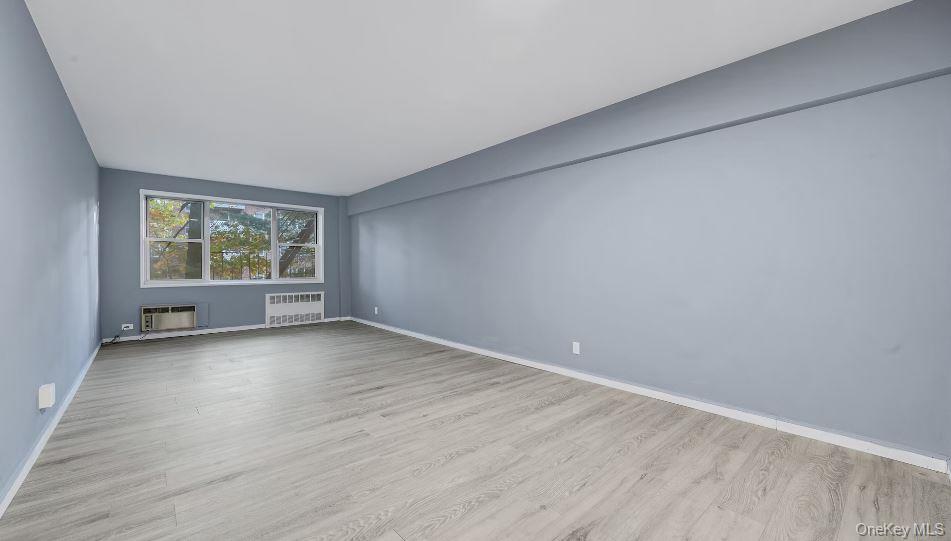609 Palmer Road, Unit 3M Yonkers, NY 10701 - Photo 8 of 18 Large, open living area showing large windows, wall A/C, Radiator.