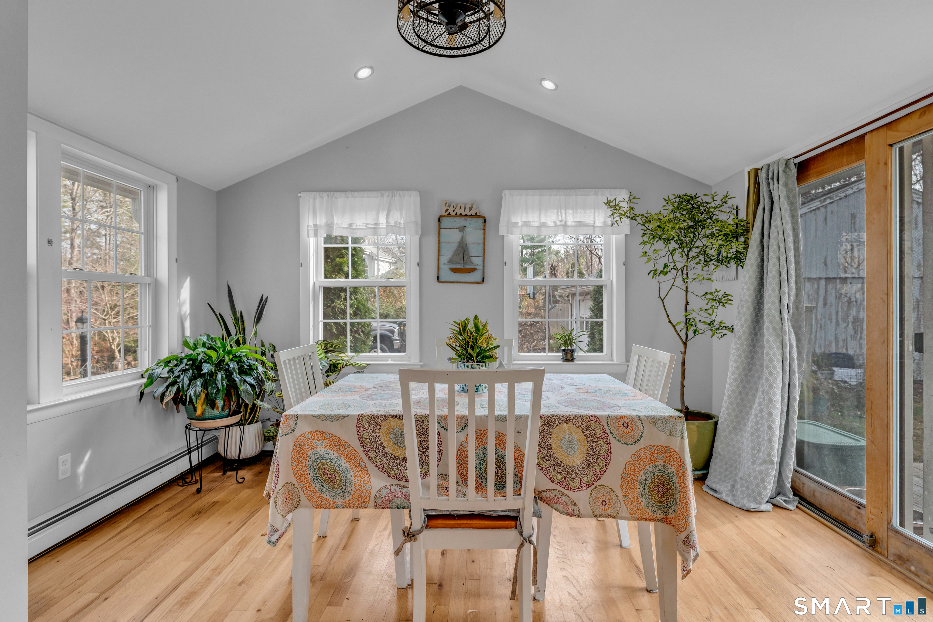 43 Fort Path Road Madison, CT 06443 - Photo 17 of 40 a view of a dining room with furniture window and wooden floor