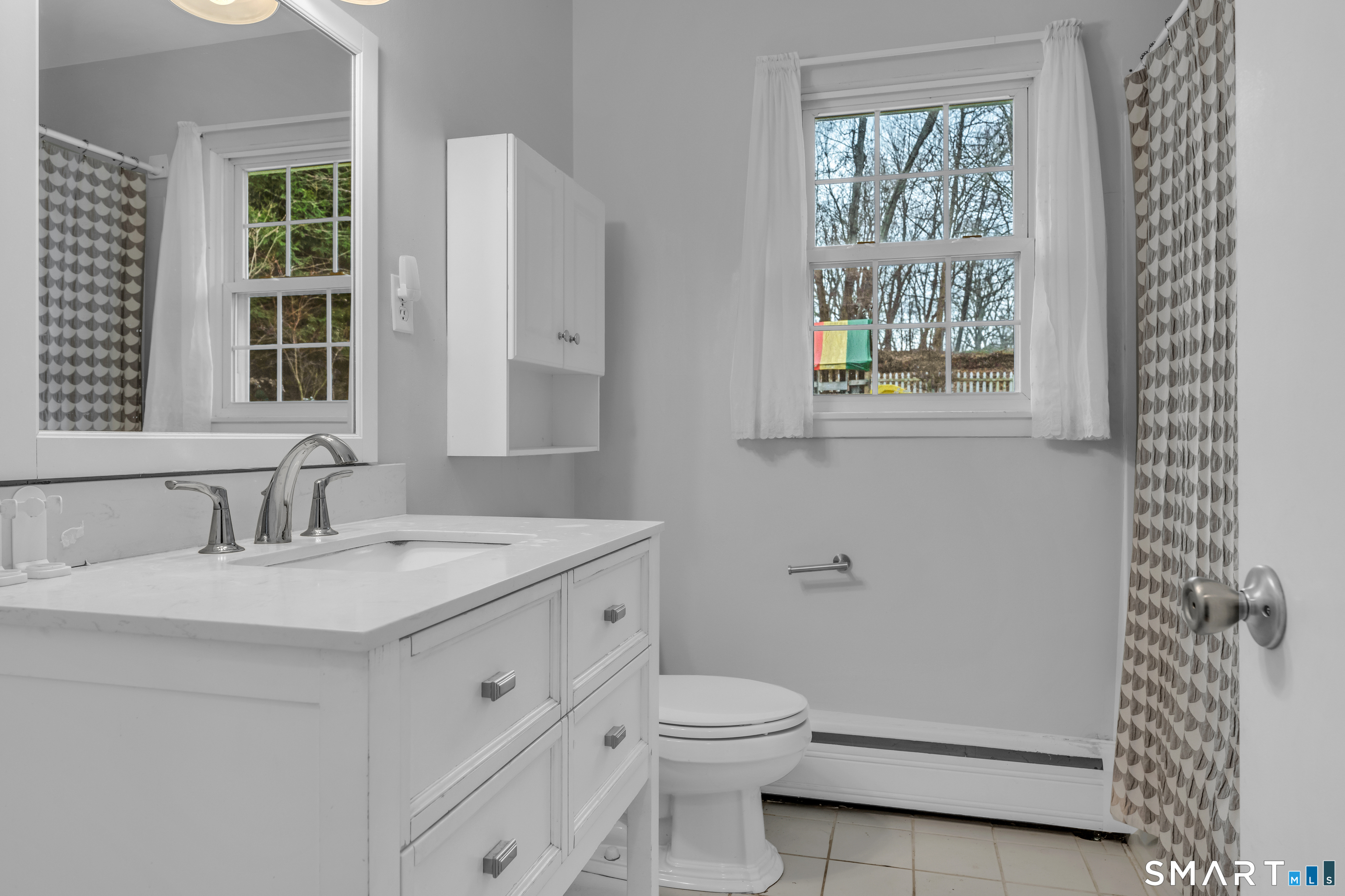 43 Fort Path Road Madison, CT 06443 - Photo 21 of 40 a bathroom with a granite countertop sink toilet and large mirror