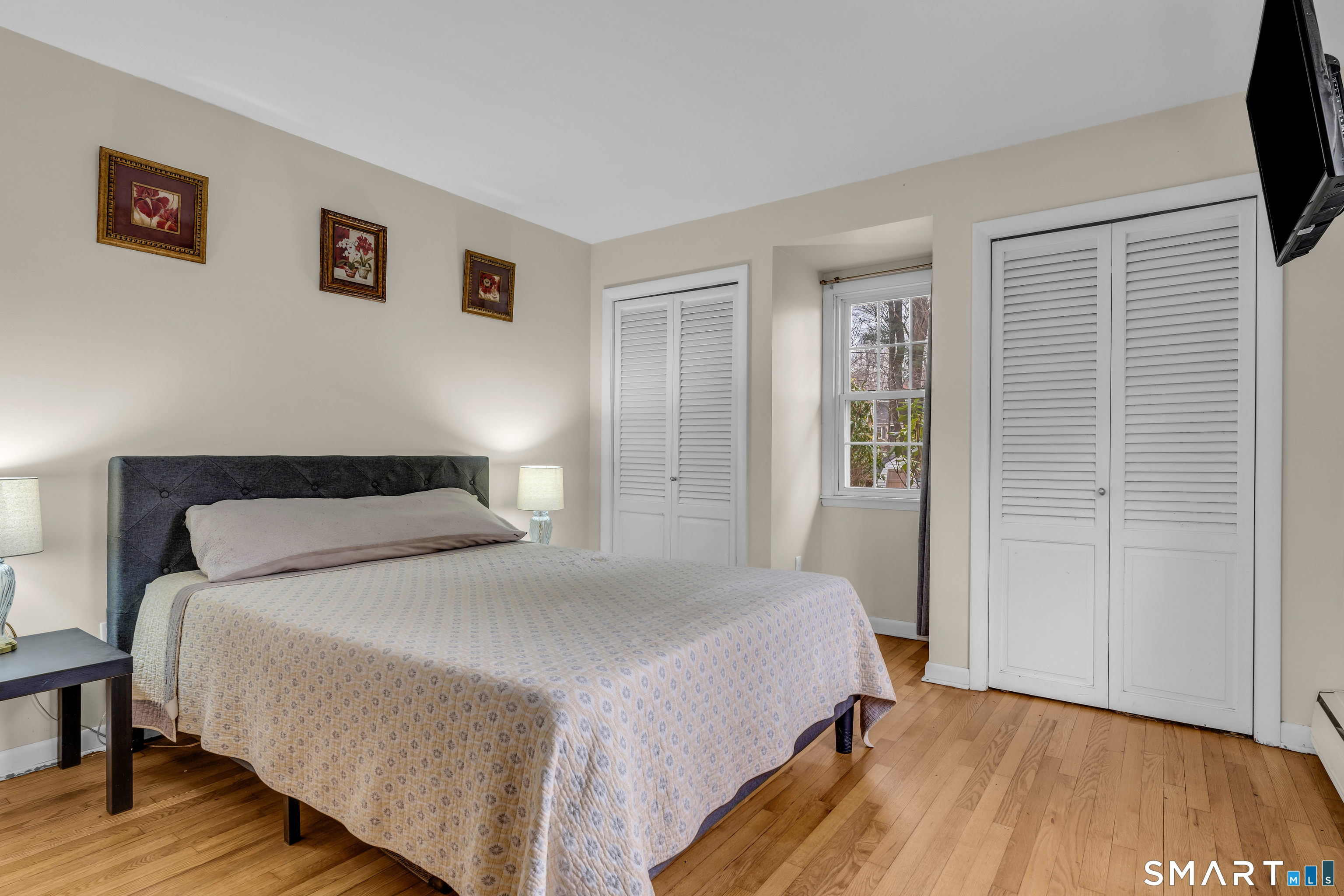 43 Fort Path Road Madison, CT 06443 - Photo 23 of 40 a bedroom with a bed and a flat screen tv