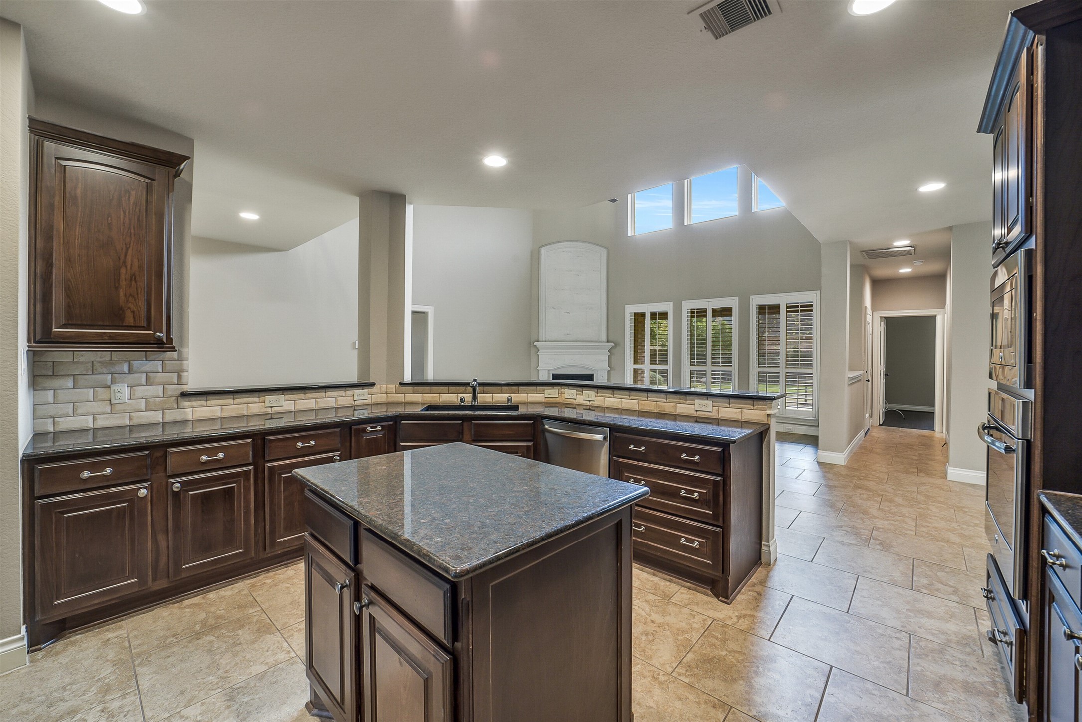 6413 Delta Crossing Court Rosenberg, TX 77471 - Photo 14 of 46 a kitchen with a stove a sink and a refrigerator