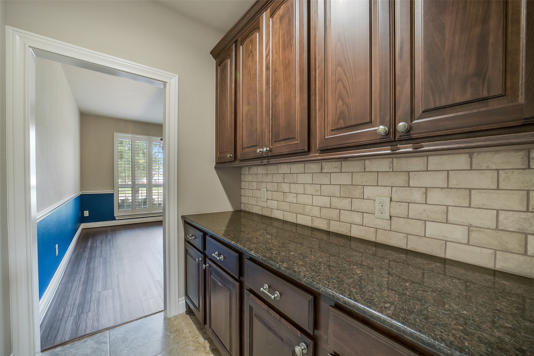 6413 Delta Crossing Court Rosenberg, TX 77471 - Photo 17 of 46 a kitchen with granite countertop a sink a stove and cabinets