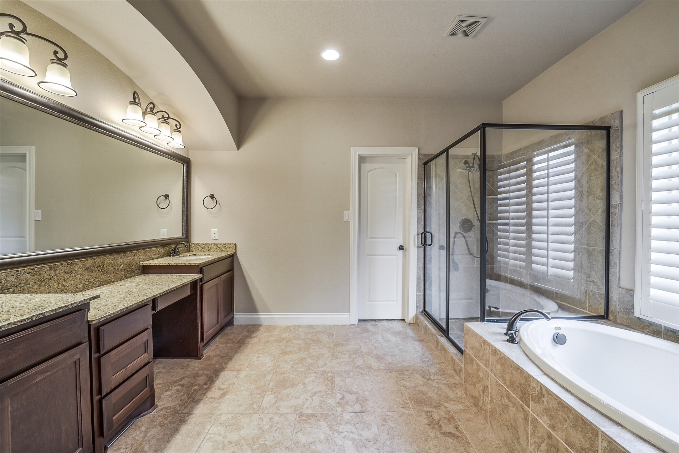 6413 Delta Crossing Court Rosenberg, TX 77471 - Photo 24 of 46 a spacious bathroom with a granite countertop tub sink and mirror