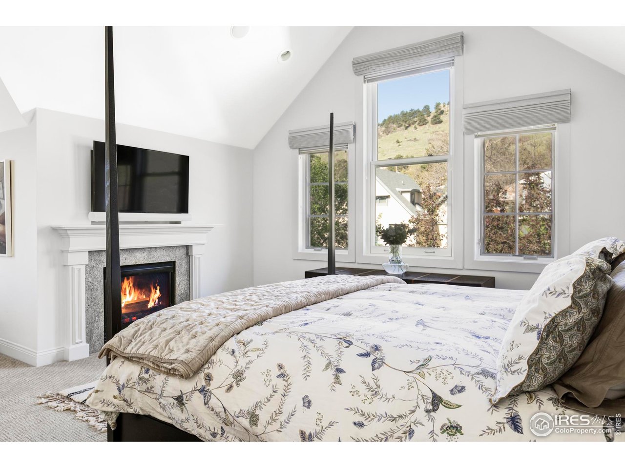 3132 5th Street Boulder, CO 80304 - Photo 15 of 27 a bedroom with a bed and a flat screen tv