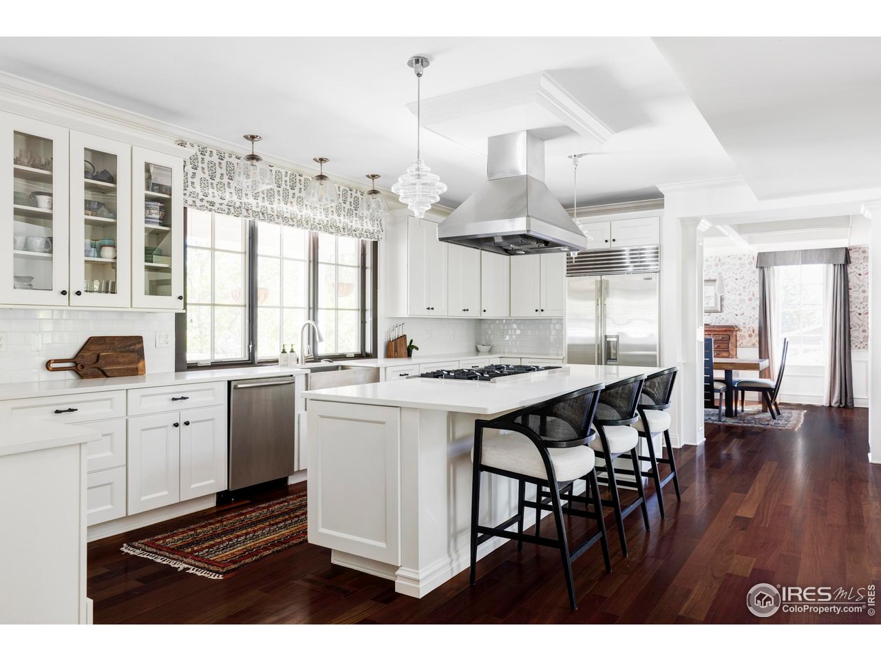 3132 5th Street Boulder, CO 80304 - Photo 5 of 27 a open kitchen with stainless steel appliances granite countertop a stove a refrigerator a sink dishwasher and white cabinets with wooden floor