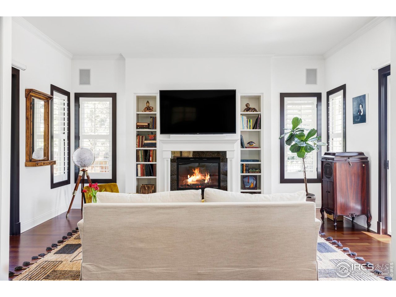 3132 5th Street Boulder, CO 80304 - Photo 7 of 27 a living room with furniture a flat screen tv and a fireplace