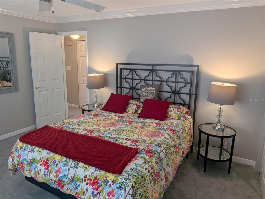 700 Starkey Road, Unit 821 Largo, FL 33771 - Photo 16 of 29 a bedroom with a bed and a lamp on table