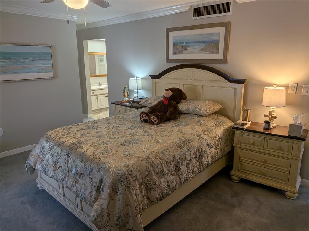 700 Starkey Road, Unit 821 Largo, FL 33771 - Photo 17 of 29 a bed sitting in a bedroom next to a lamp