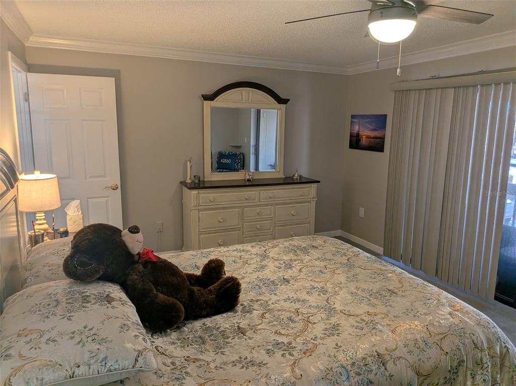 700 Starkey Road, Unit 821 Largo, FL 33771 - Photo 18 of 29 a bedroom with a bed window and dresser