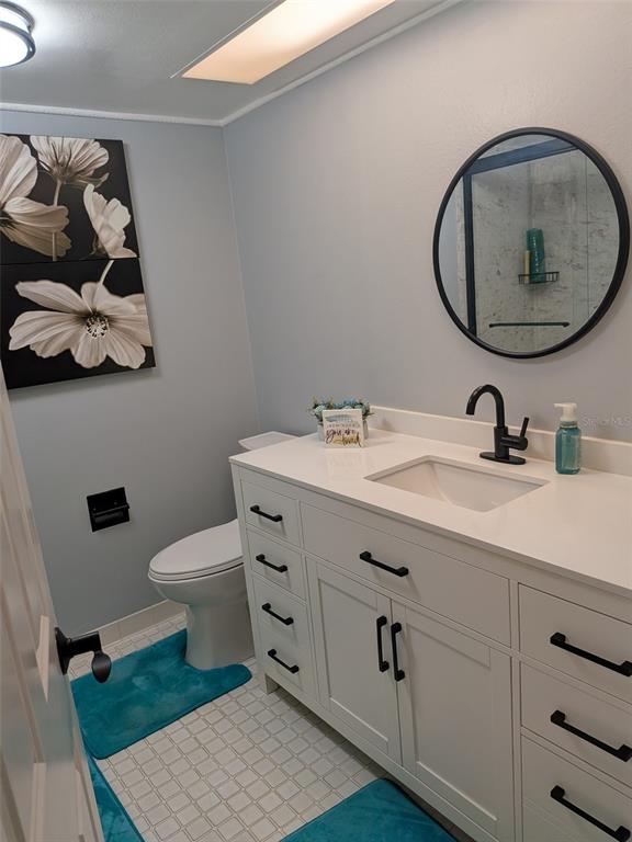 700 Starkey Road, Unit 821 Largo, FL 33771 - Photo 20 of 29 a bathroom with a toilet sink and mirror