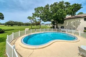 700 Starkey Road, Unit 821 Largo, FL 33771 - Photo 28 of 29 a view of a swimming pool with a garden