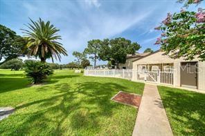 700 Starkey Road, Unit 821 Largo, FL 33771 - Photo 29 of 29 a front view of a house with a yard and potted plants