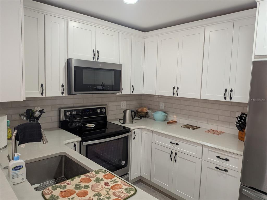 700 Starkey Road, Unit 821 Largo, FL 33771 - Photo 6 of 29 a kitchen with a sink and cabinets