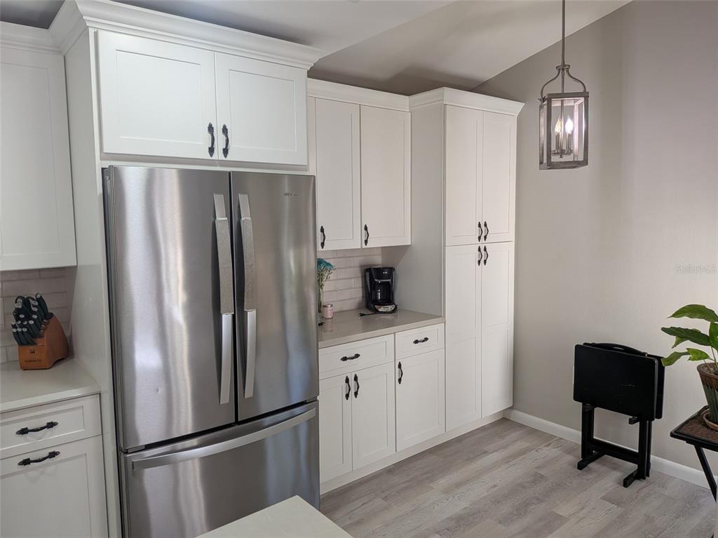 700 Starkey Road, Unit 821 Largo, FL 33771 - Photo 8 of 29 a kitchen with stainless steel appliances a refrigerator and cabinets