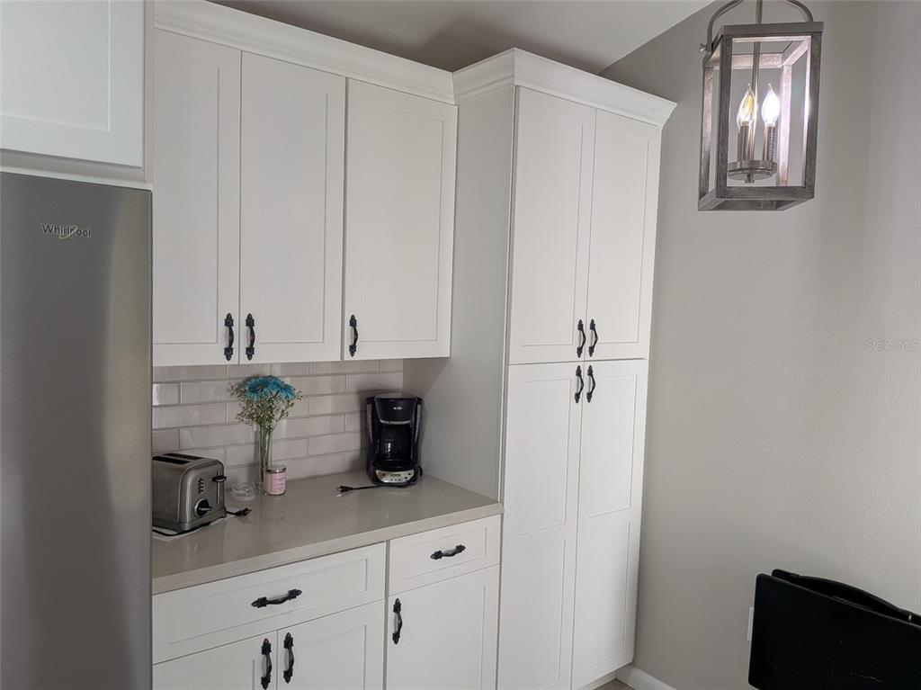 700 Starkey Road, Unit 821 Largo, FL 33771 - Photo 9 of 29 a kitchen with a refrigerator and cabinets
