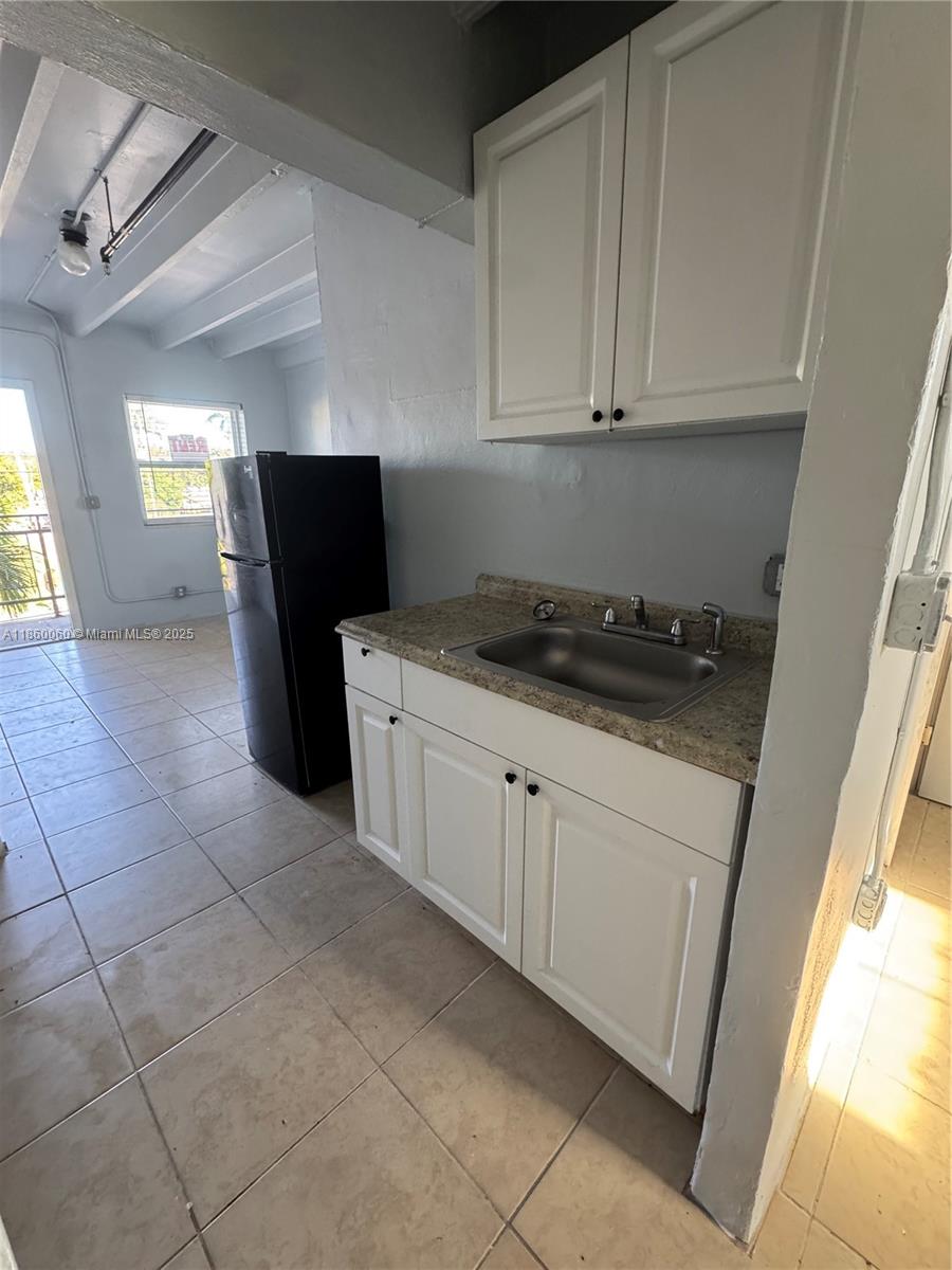 354 Rardin Avenue, Unit 12 Pahokee, FL 33476 - Photo 3 of 11 a kitchen with a sink and cabinets