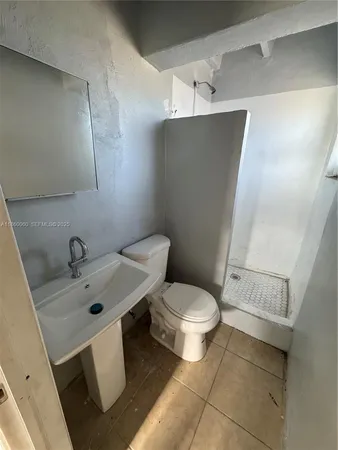 a white toilet sitting next to a bathroom sink