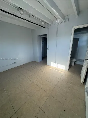 a view of an empty room with a bathroom