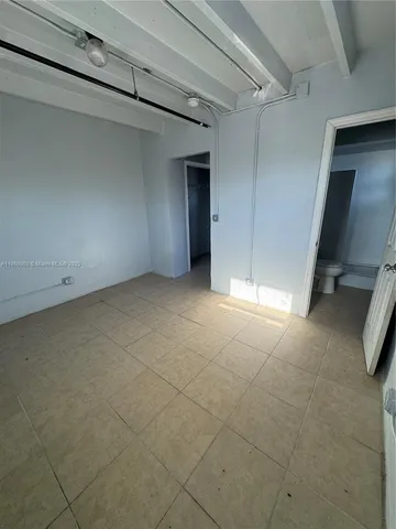 a view of an empty room with a bathroom