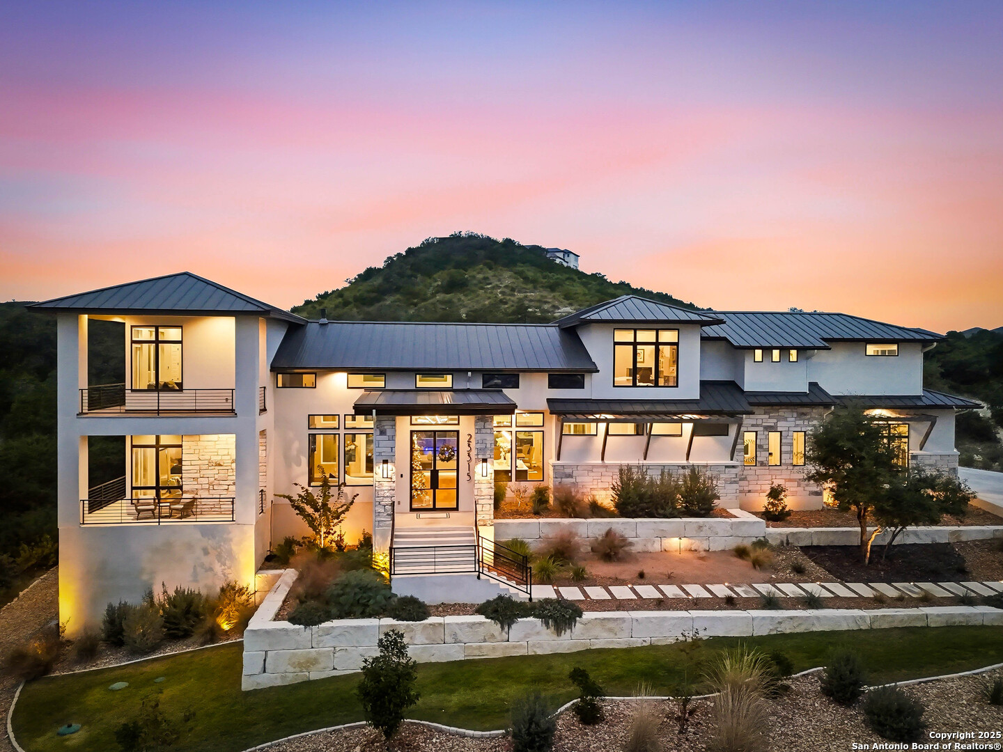 a front view of a house with lake view and a yard