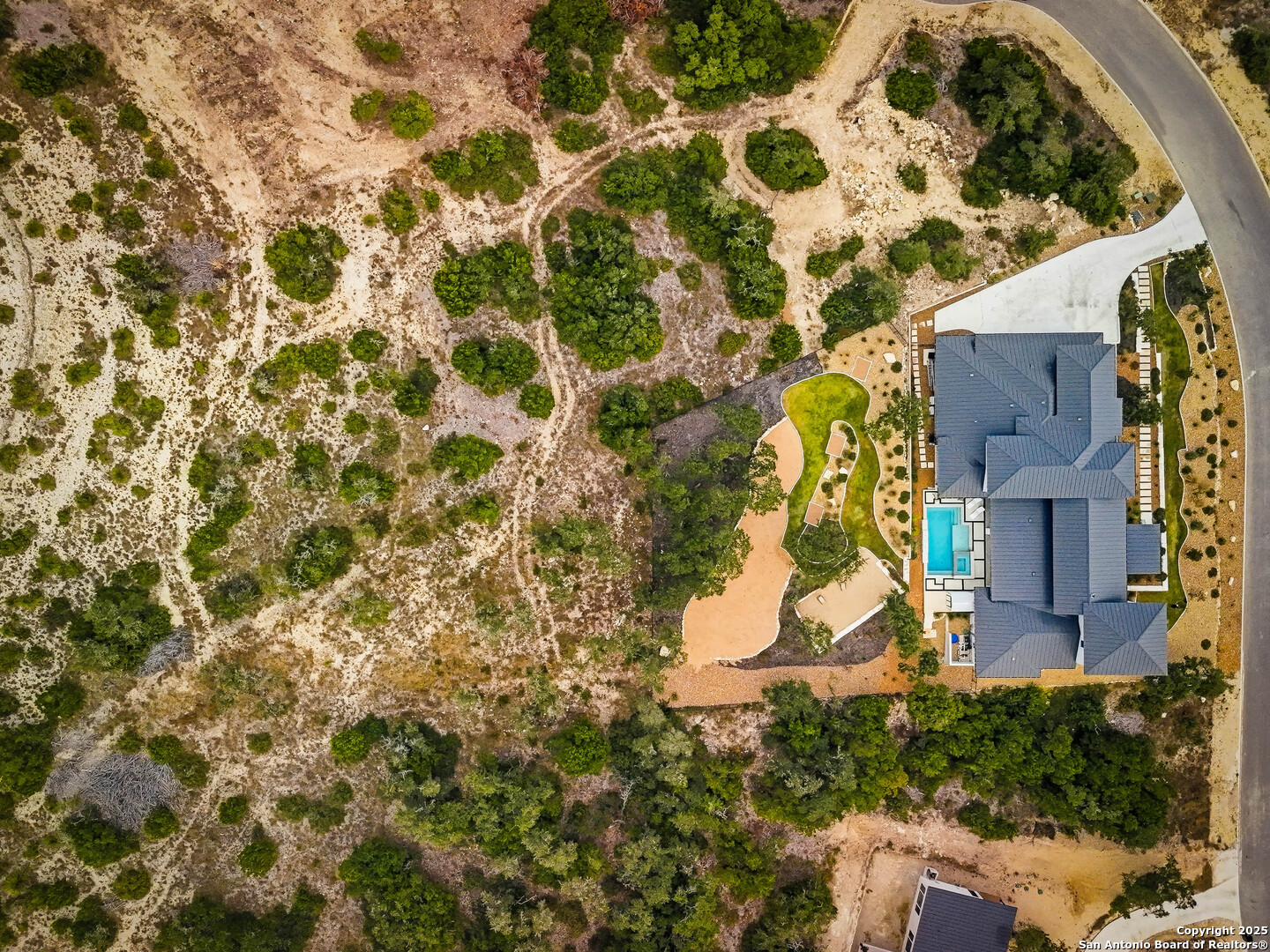 23315 Ebner Ridge San Antonio, TX 78255 - Photo 3 of 103 an aerial view of a house with a yard and large trees