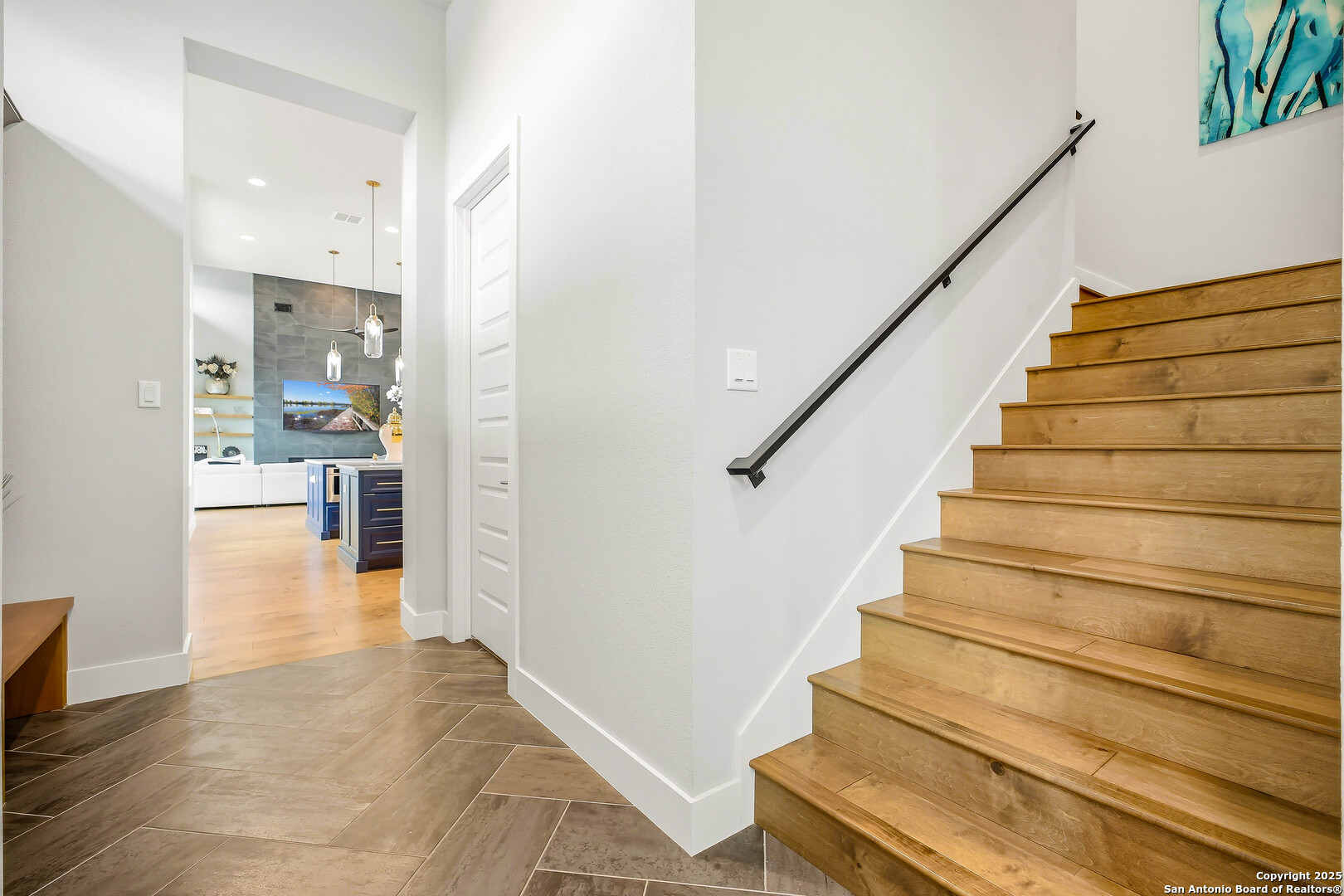 23315 Ebner Ridge San Antonio, TX 78255 - Photo 45 of 103 a view of an entryway with wooden floor and a living room