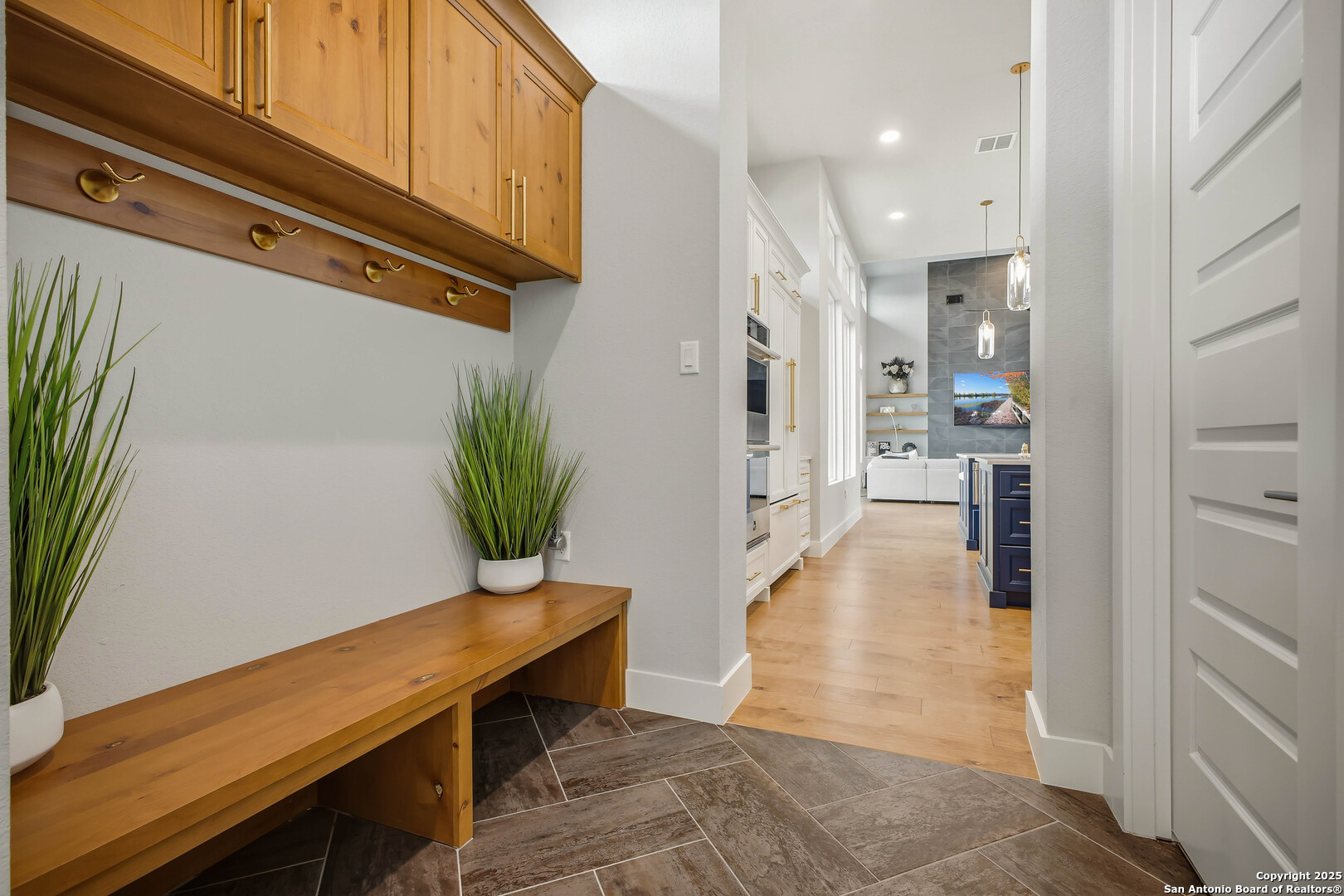 23315 Ebner Ridge San Antonio, TX 78255 - Photo 59 of 103 a view of a hallway with wooden floor and a potted plant