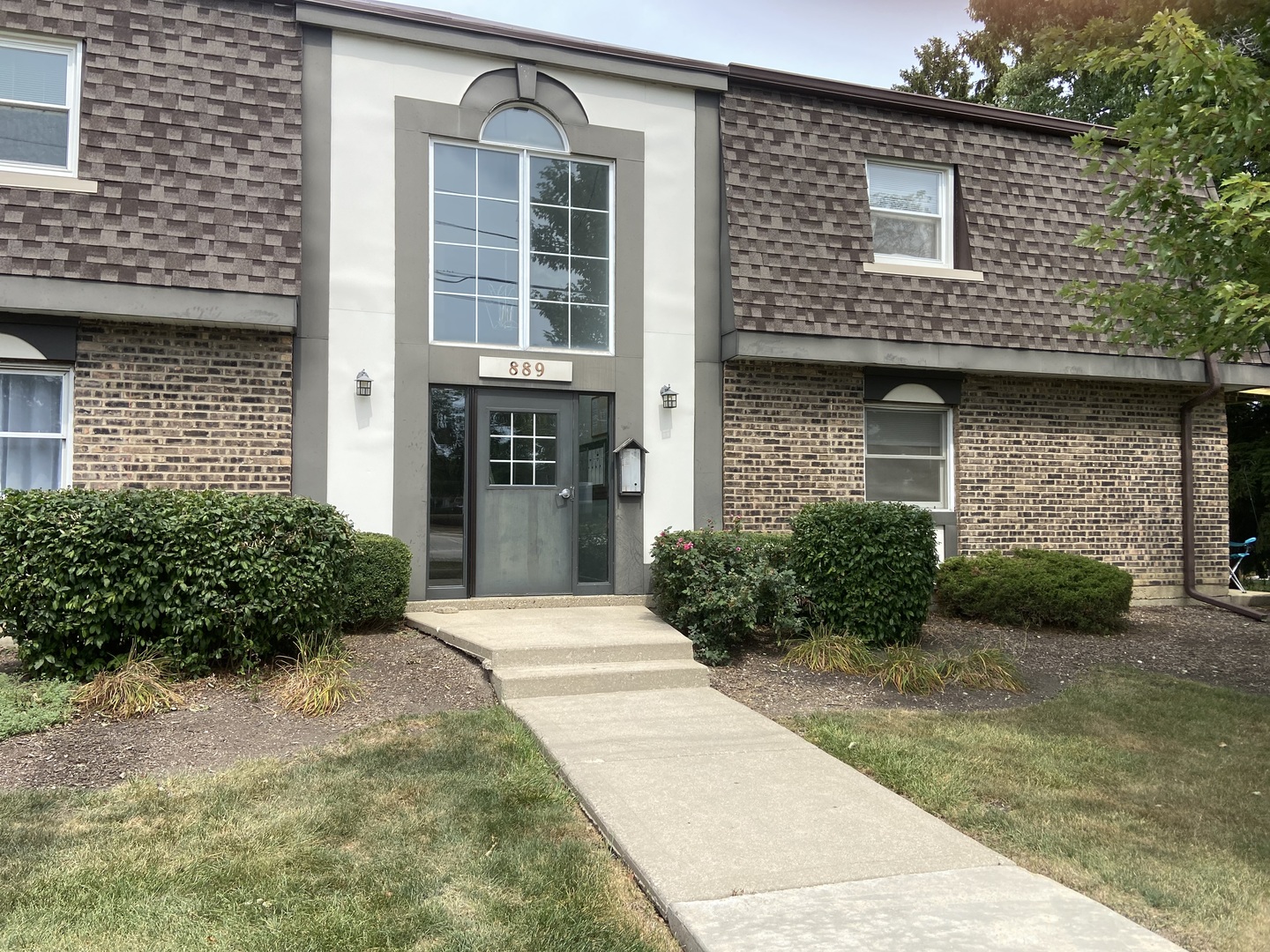 a front view of a house with a garden