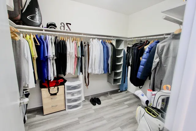 a view of walk in closet with clothes