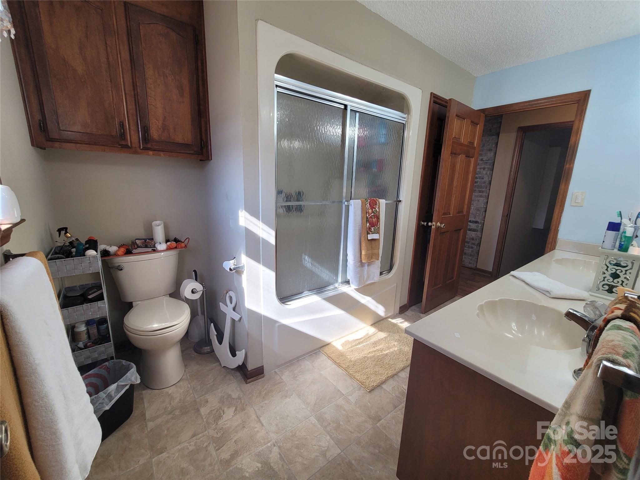 1349 High Shoals Road Lincolnton, NC 28092 - Photo 26 of 42 a bathroom with a sink a toilet and a shower