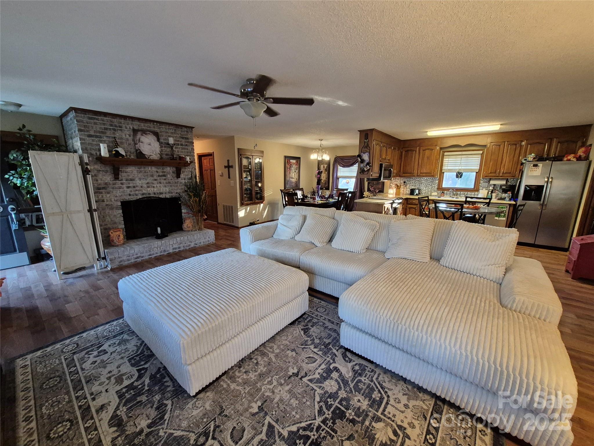 1349 High Shoals Road Lincolnton, NC 28092 - Photo 9 of 42 a living room with furniture a fireplace and a flat screen tv