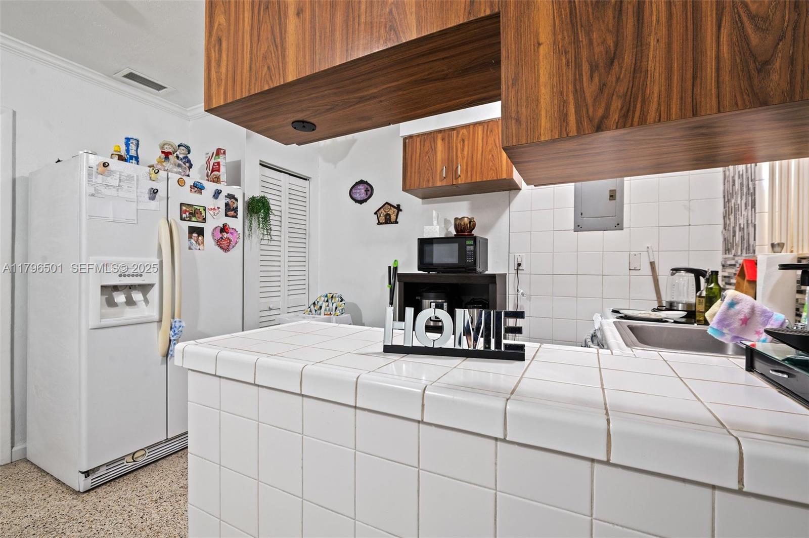 Hialeah Acres Hialeah, FL 33010 - Photo 19 of 55 a bedroom with a bed and a white cabinet