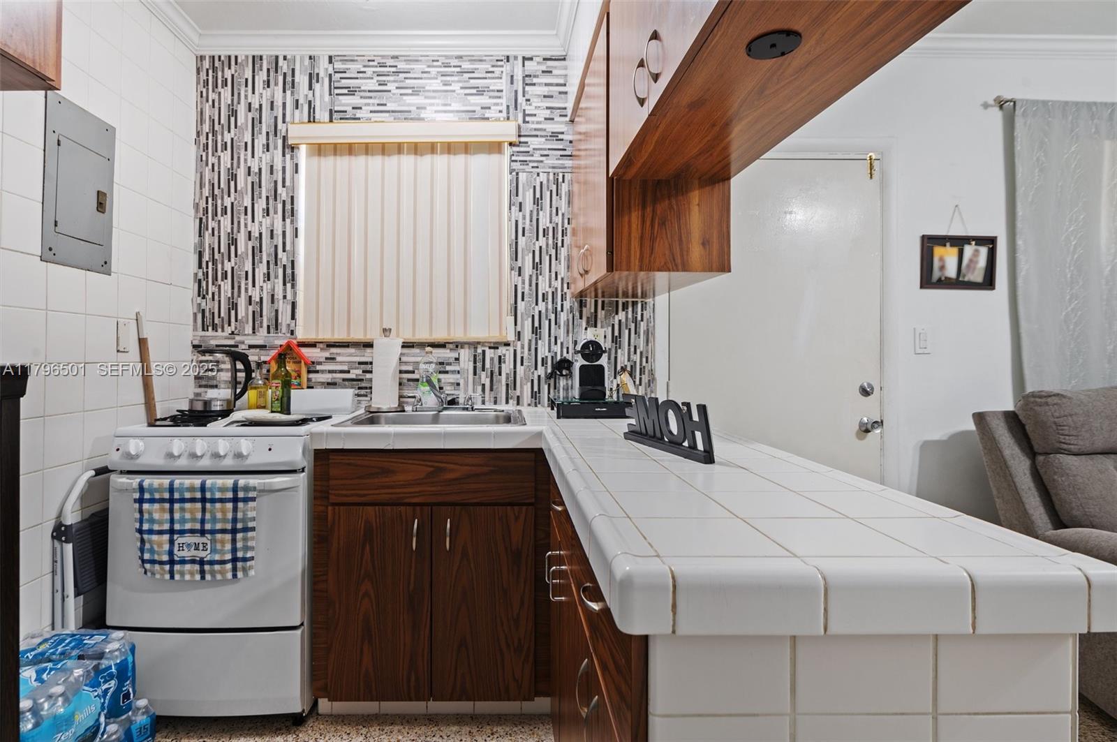 Hialeah Acres Hialeah, FL 33010 - Photo 21 of 55 a kitchen with stainless steel appliances a stove a sink and a refrigerator