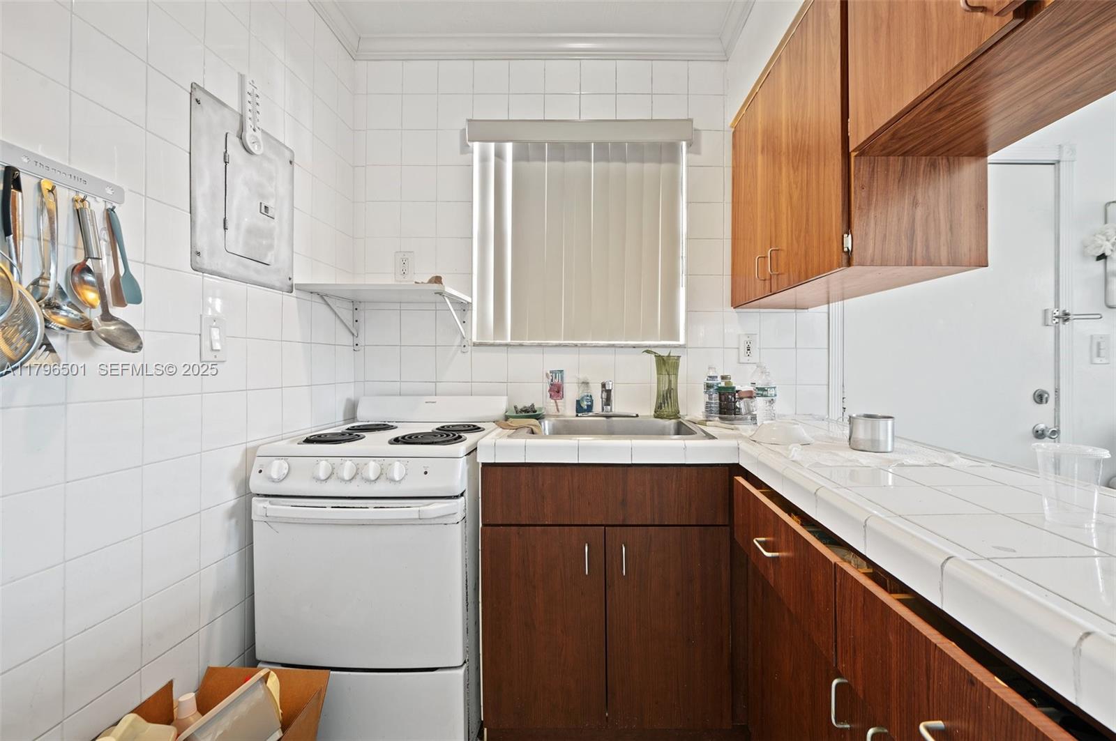 Hialeah Acres Hialeah, FL 33010 - Photo 42 of 55 a kitchen with a sink stove and cabinets