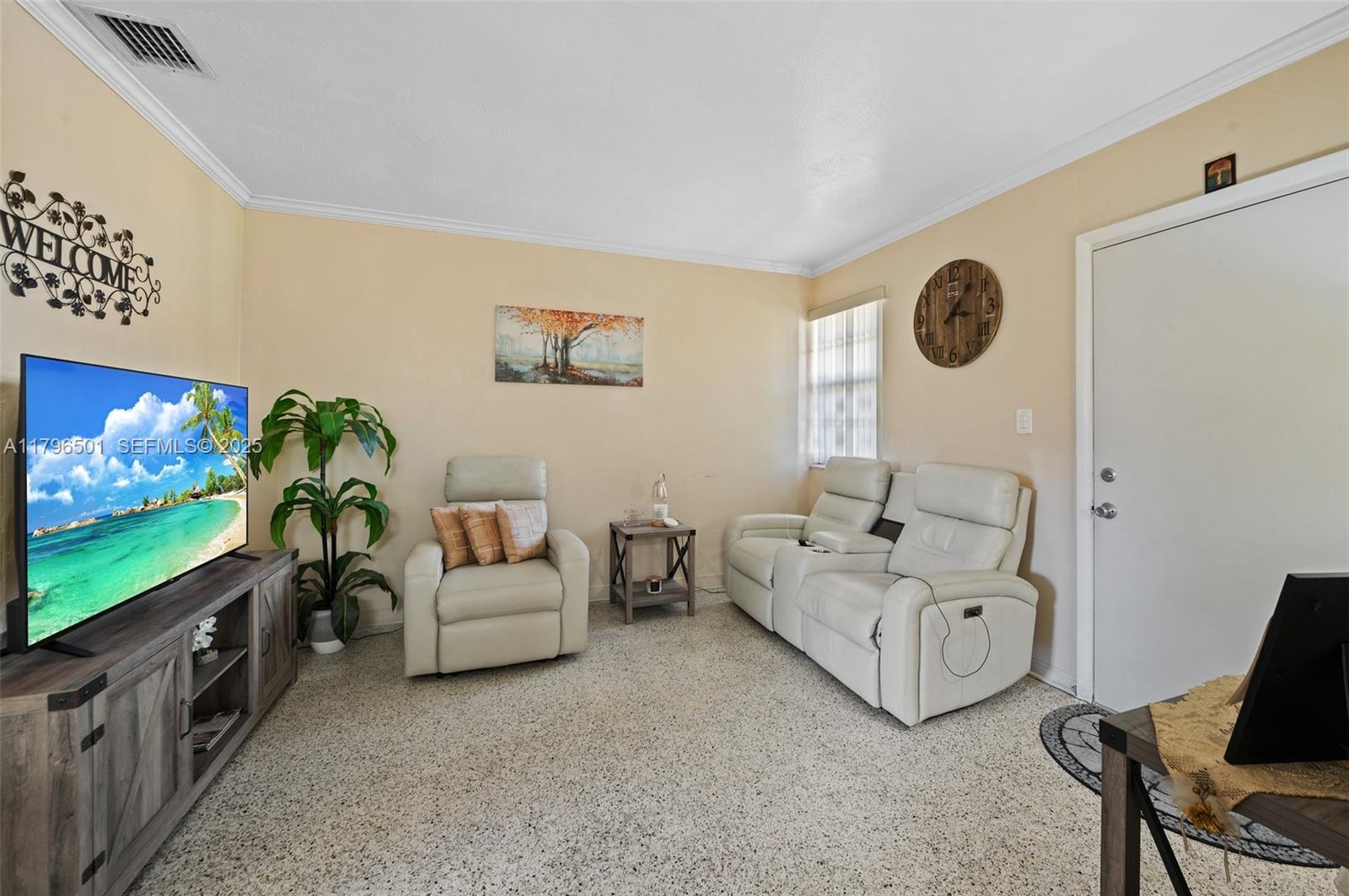 Hialeah Acres Hialeah, FL 33010 - Photo 7 of 55 a living room with furniture and a flat screen tv