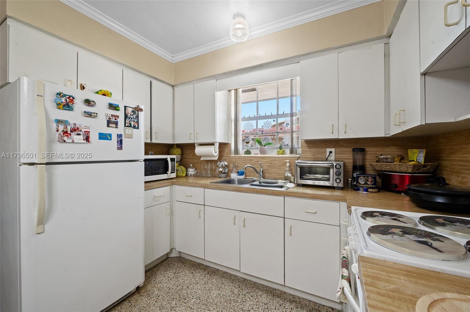 Hialeah Acres Hialeah, FL 33010 - Photo 10 of 55 a kitchen with stainless steel appliances granite countertop a refrigerator and a sink