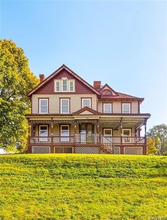 a large pool that has lawn chairs near a big yard