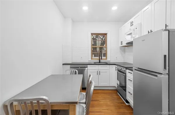 a kitchen with cabinets and a refrigerator