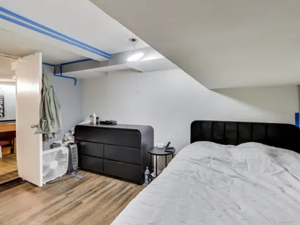 a bedroom with a bed and a mirror