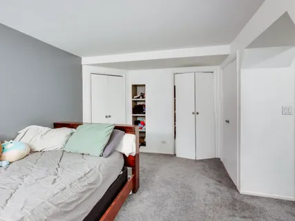 a bed room with a bed and a window