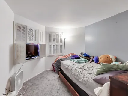 a bedroom with a bed and flat screen tv
