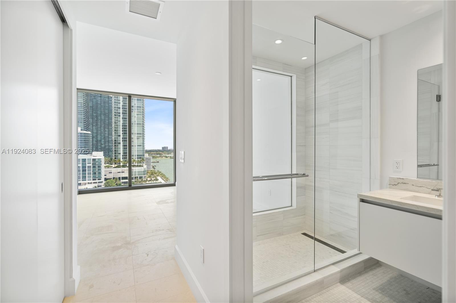 700 Northeast 26th Terrace, Unit 1406 Miami, FL 33137 - Photo 12 of 41 a bathroom with a shower and a sink