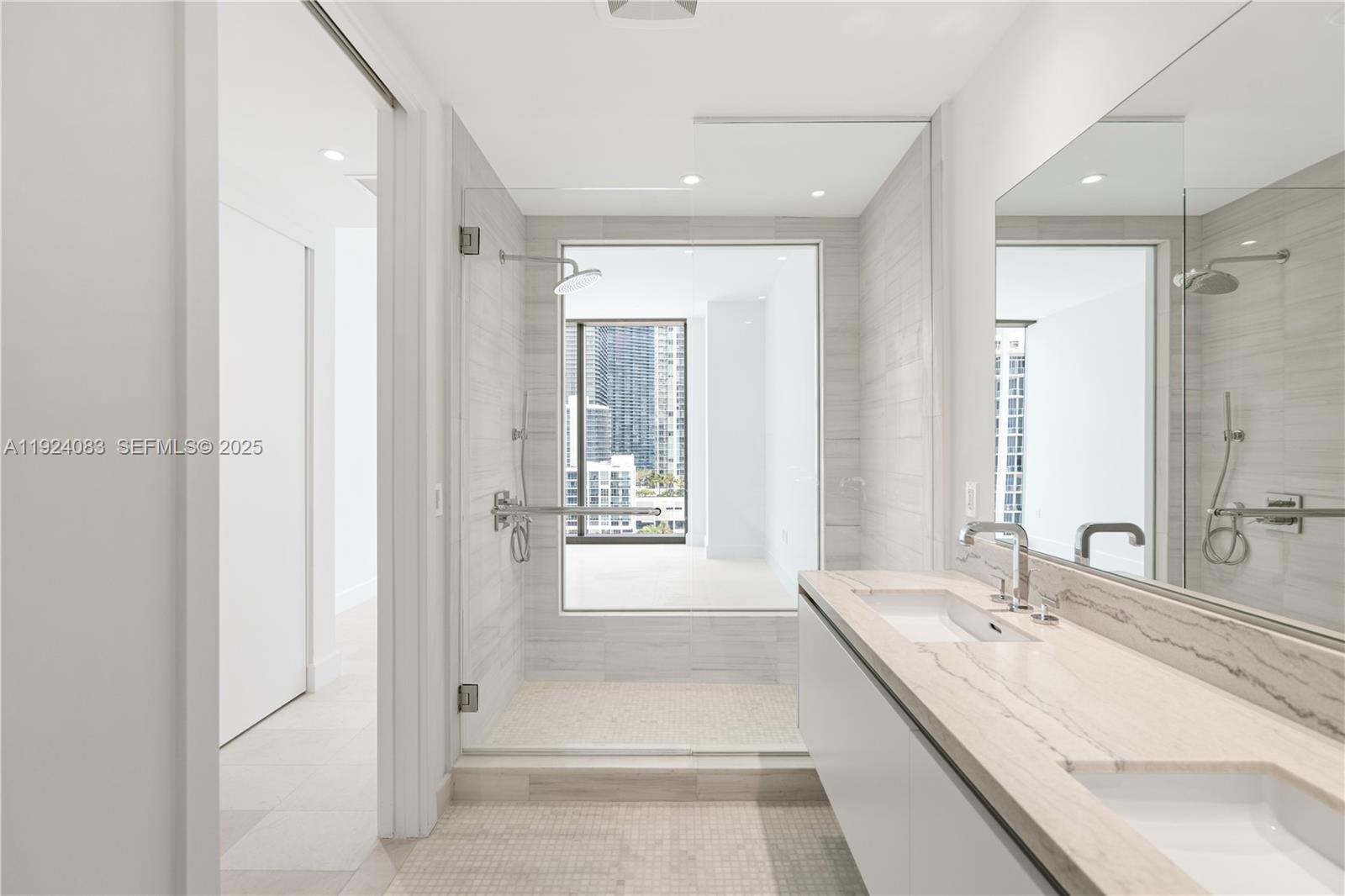 700 Northeast 26th Terrace, Unit 1406 Miami, FL 33137 - Photo 17 of 41 a large bathroom with a tub shower and sink