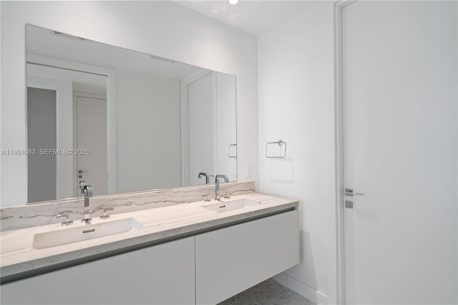 700 Northeast 26th Terrace, Unit 1406 Miami, FL 33137 - Photo 19 of 41 a bathroom with a double vanity sink and mirror
