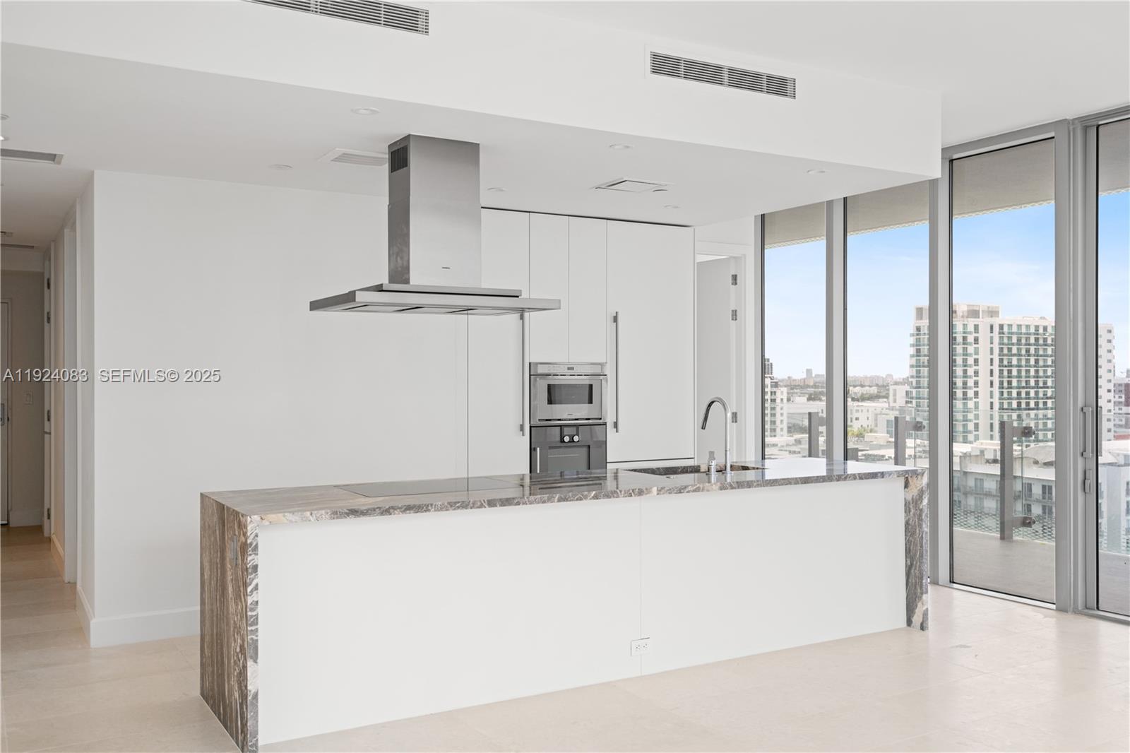 700 Northeast 26th Terrace, Unit 1406 Miami, FL 33137 - Photo 29 of 41 a kitchen with kitchen island and a large window