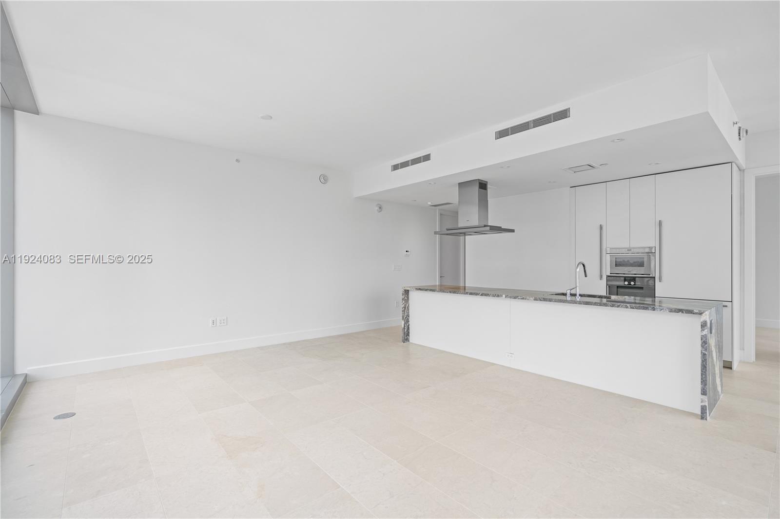 700 Northeast 26th Terrace, Unit 1406 Miami, FL 33137 - Photo 32 of 41 a view of kitchen with refrigerator and white cabinets