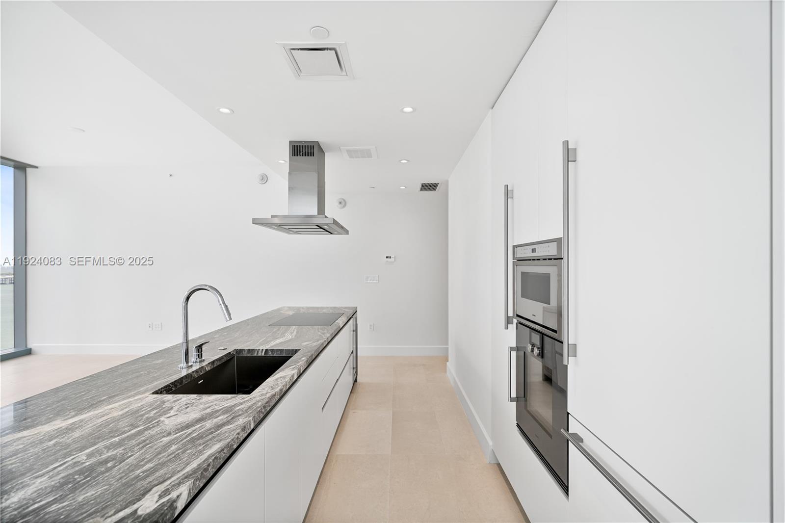 700 Northeast 26th Terrace, Unit 1406 Miami, FL 33137 - Photo 33 of 41 a kitchen with stainless steel appliances granite countertop a sink and refrigerator